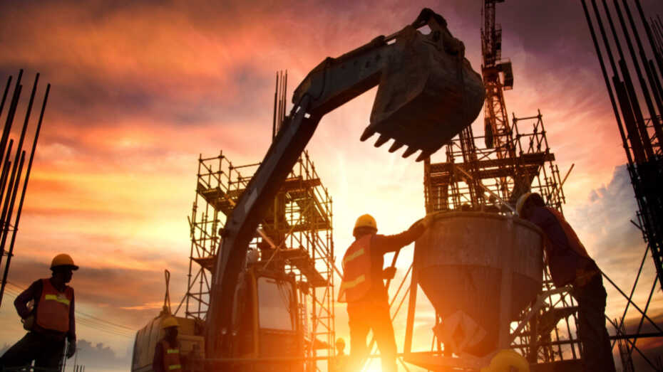 Construction workers laying cement